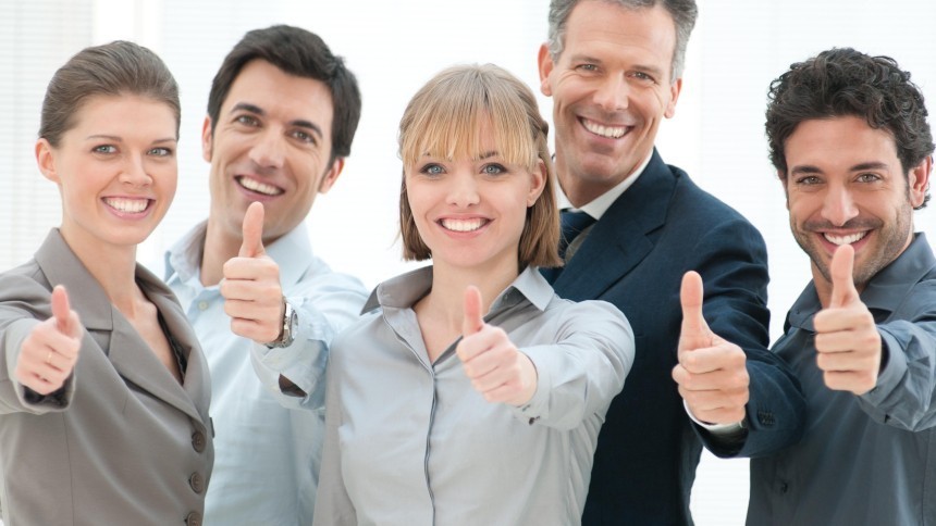 A group of 5 people showing thumbs up