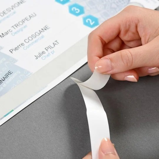 Peeling the protective tape from the name