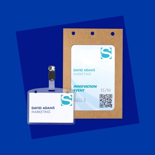 Two event name badges on a blue background. A smaller, simple badge in a plastic holder with a clip shows a logo, the name David Adams, and Marketing. A larger pass on a cardboard holder includes the same, plus event details like 'Innovation Event', 'Hall 5', a date, and a QR code.
