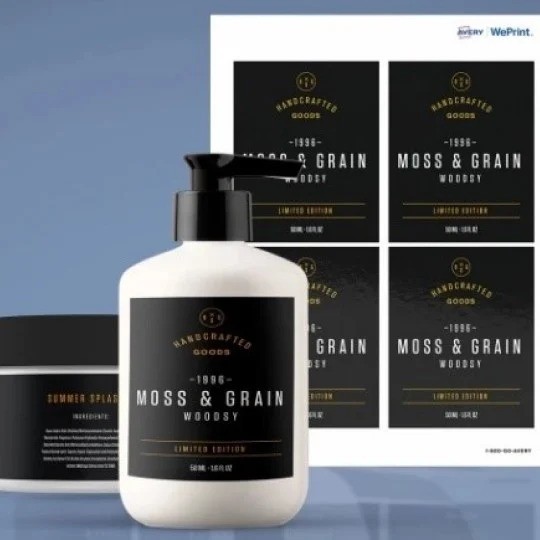 A white bottle and jar with custom black "MOSS & GRAIN" product labels are shown in front of a sheet of the same printed labels.