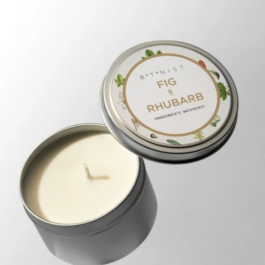Candle in a container and a lid with a label