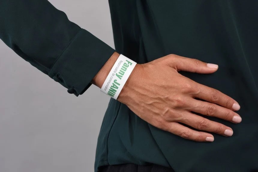 Hand on dark cloth with light wrist band