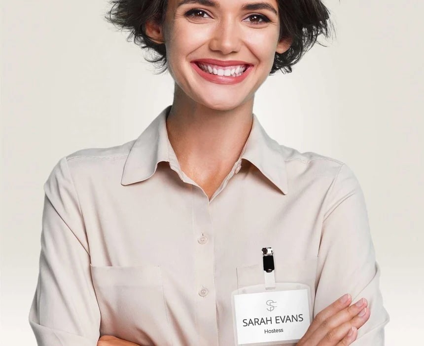 A woman with a name tag with a clip pinned to her shirt