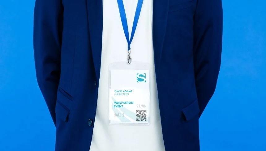 Man with coloured lanyard with name tag in A6 format