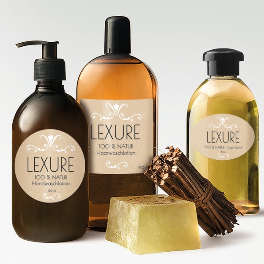A selection of natural cosmetics from the LEXURE brand. Pictured are: hand soap in a dark bottle with a pump, hair conditioner in a bottle containing amber-colored liquid, and shower gel. Next to them lies a bar of handmade soap and a bunch of dried roots. The labels are retro-style on beige paper.